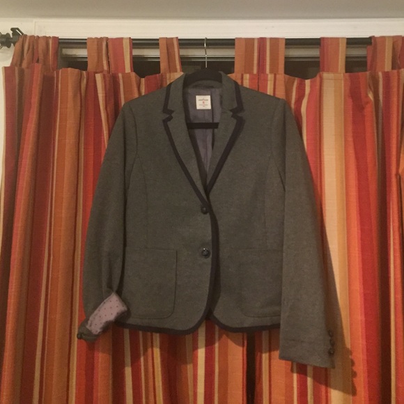 Grey blazer with navy piping.