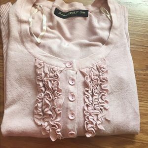 A soft/light pink sweater