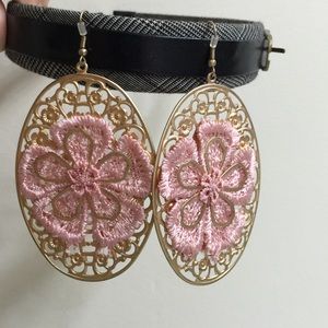 Gold earrings with pink fabric.