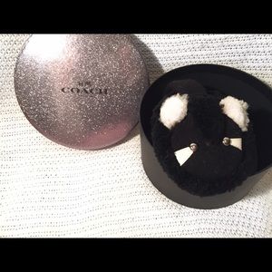 COACH raccoon ear muffs.