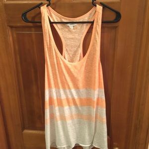 Slightly neon orange, razor back tank top.