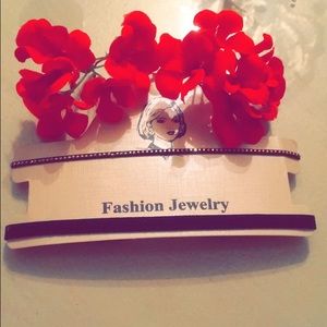 Two black chokers. One with gold small studs.