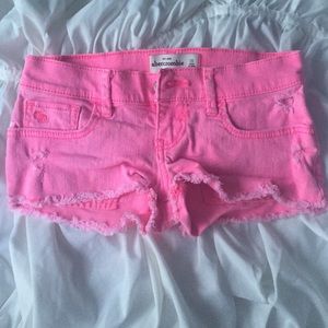 Neon pink cutoff jean shorts
