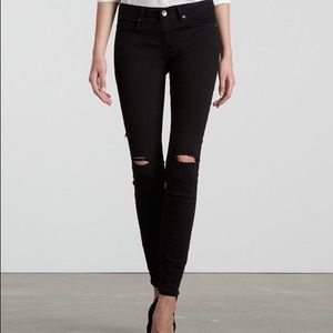 Distressed black skinny jeans