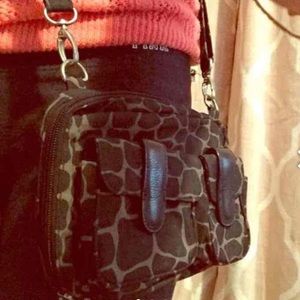 Crossbody giraffe print travel bag.