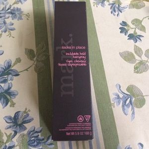 Mark. Locks in Place Hairspray