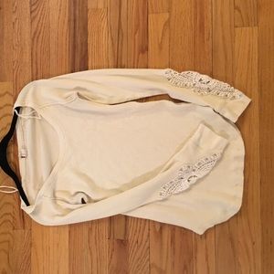 Free people waffle shirt with embroidered sleeves.