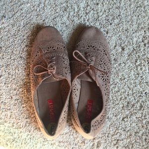Tan loafers with lace detail.