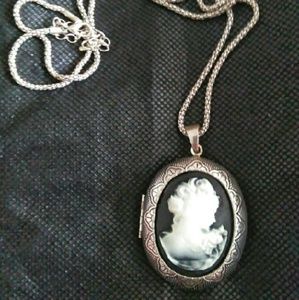 Silver and black oval locket