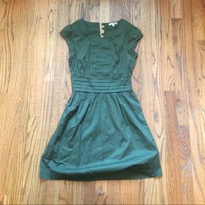 Structured fit and flair with button back.