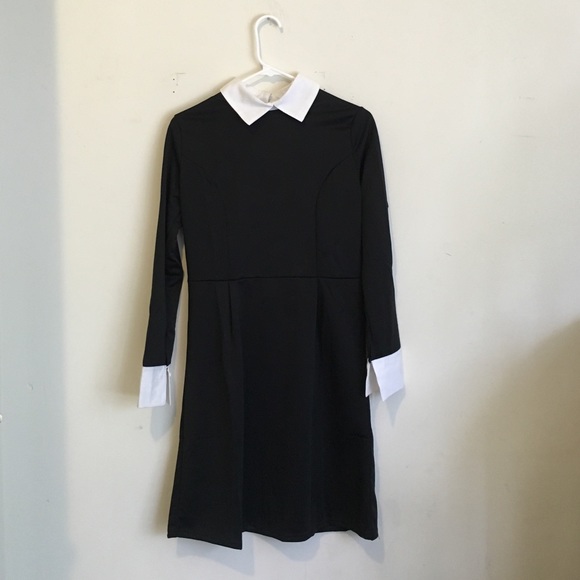 Black dress with white collar and cuffs . Zip up