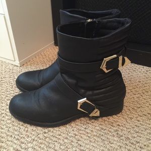 Black booties with gold buckle detail
