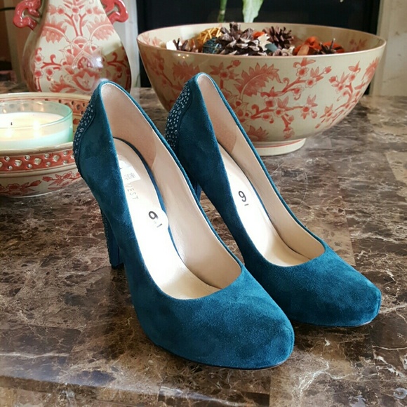 Teal blue suede pumps with rhinestone on  heels.
