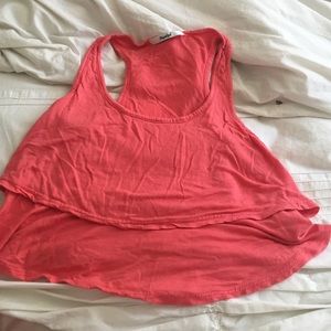 A coral color ruffle crop top