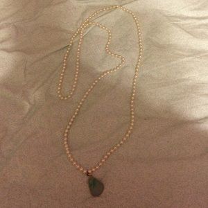 Long pearl necklace with stone at the end