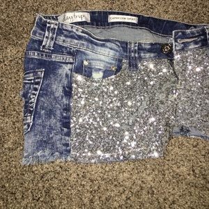 Distressed jean shorts with sequins on front