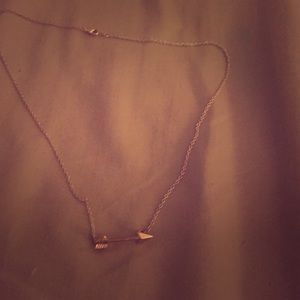 Delicate rose-gold arrow necklace.