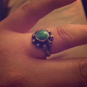 Silver ring with green stone.