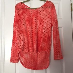 A fun peach colored sweater with holes.