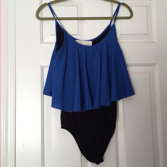 A blue flowy top and bottom black leotard.