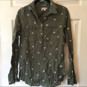 Green collared shirt with elephants