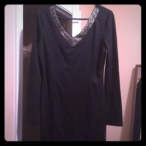 black dress with silver jewelry around neck