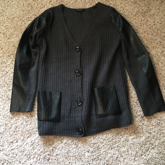 Dark grey knit sweater with black leather detail.