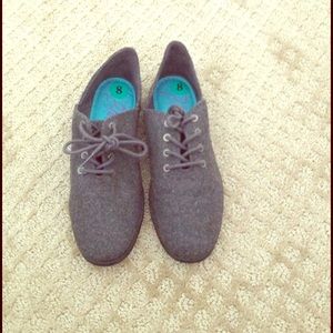 Grey lace up shoes.