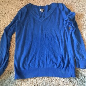 Blue v-neck sweater.