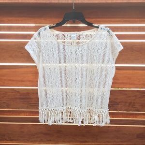 Cream colored lace shirt with fringe.