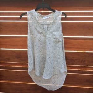 Cream and black patterned blouse.