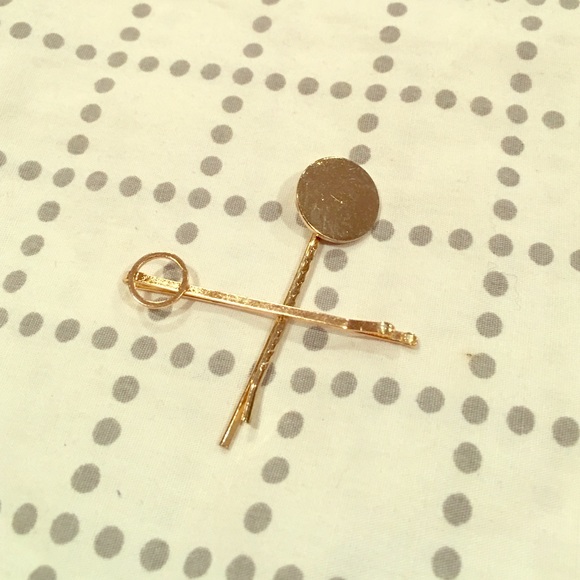 Two gold geometric bobby pins.
