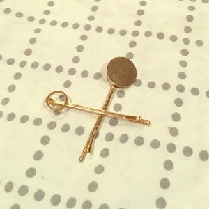 Two gold geometric bobby pins.