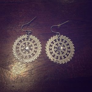 4 pairs of silver and white earrings.