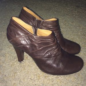 Ankle high, brown leather boots.