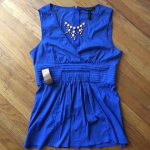 BCBG Maxazria light blue sleeveless blouse.