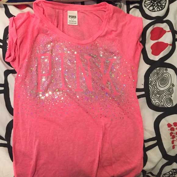 Pink shirt with pink logo written in sparkles
