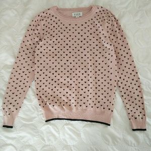 Delicate pink sweater with black hearts