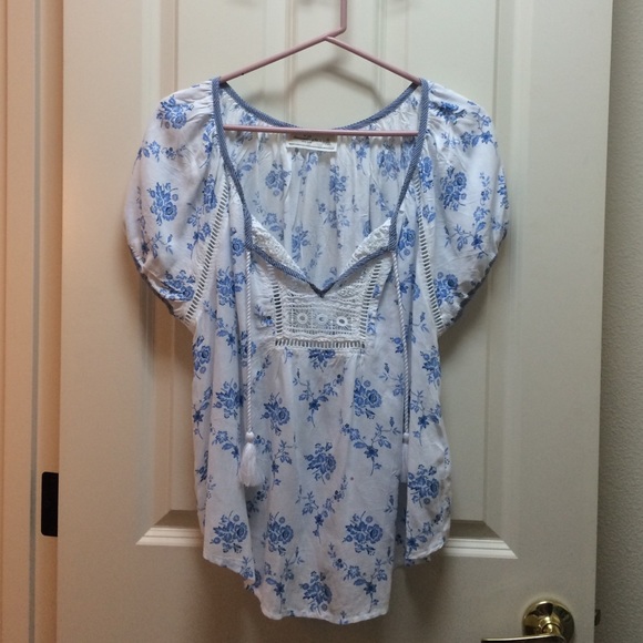 Floral printed blouse with tassel detail.