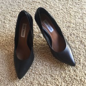 Black leather pointed heels.