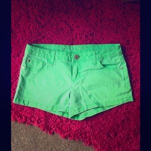 Bright green denim shorts.