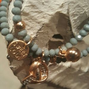Gray/Blue Beaded Bracelet  with gold color heart .