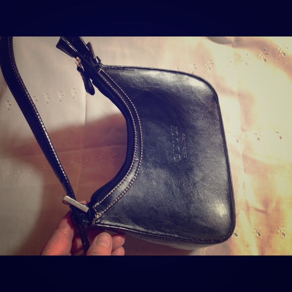 Small black purse stamped Gucci made in Italy.