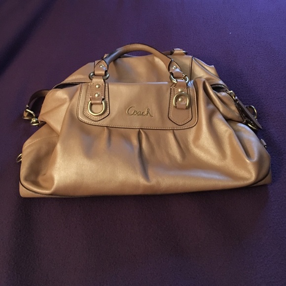 Coach bag with gold chain straps .