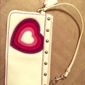 Coach wristlet with hearts embroidered.