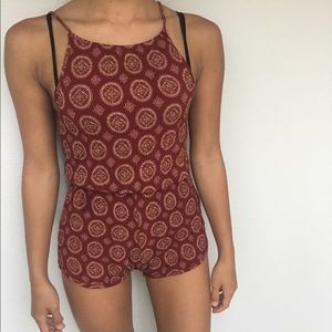 patterned red and gold romper