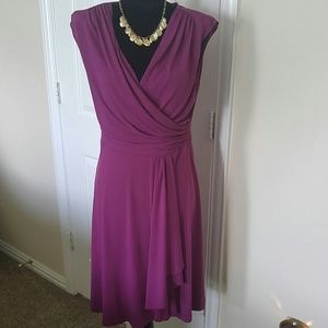 Sleeveless dress with side ruffle.