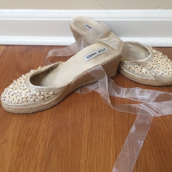 Beaded cream espadrilles with ribbon ties.