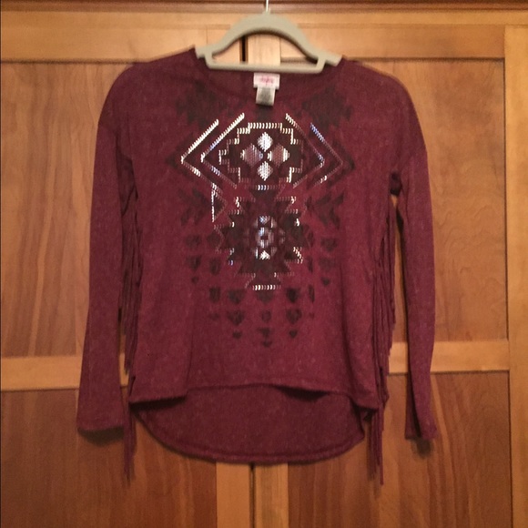 Burgundy top with fringe and design.