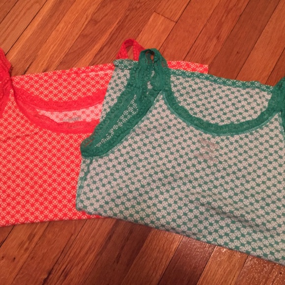 a pair of printed and lace tanks